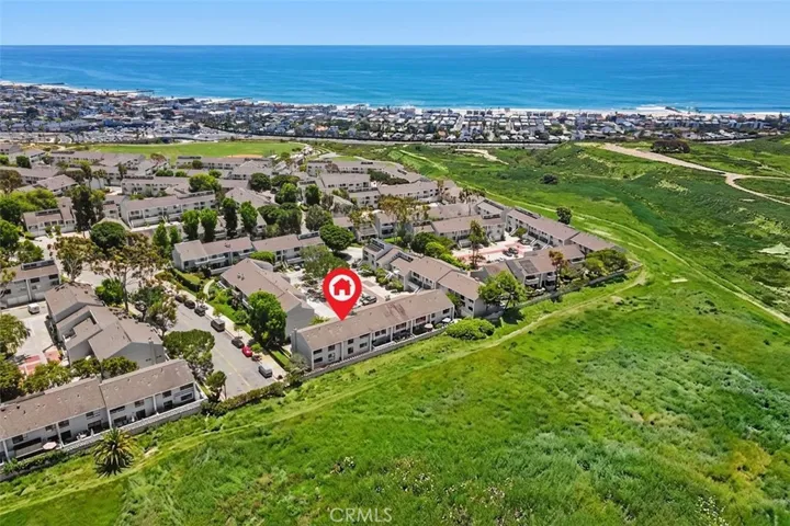 This photo has been digitally enhanced for a greener open space while showing the balcony and rear views of the Randall Preserve as well as Ocean and Sunset views!