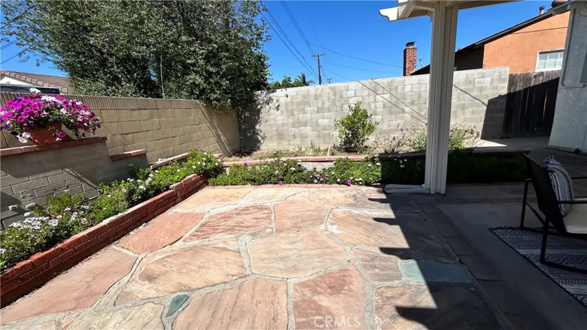 Flagstone Patio with gardens and loaded Pomegranate tree!