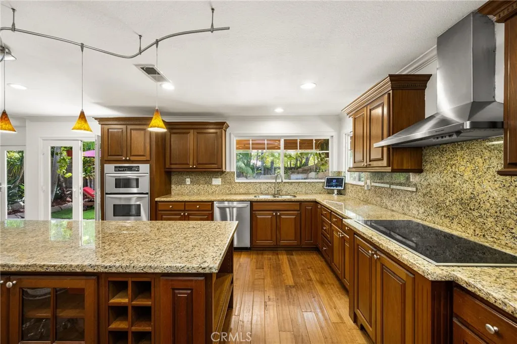 Extra large kitchen area with Lots of seats and extra cabinets, recessed lights.