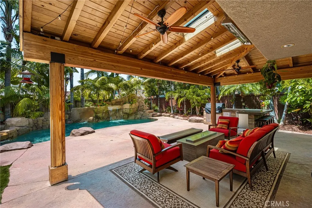 Sitting outside with the cover hang with a ceiling fan looking the beautiful Private swimming pool and the lush landscape....