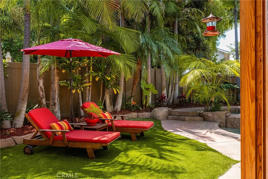 Lush landscape in backyard near the pool with a sitting area.