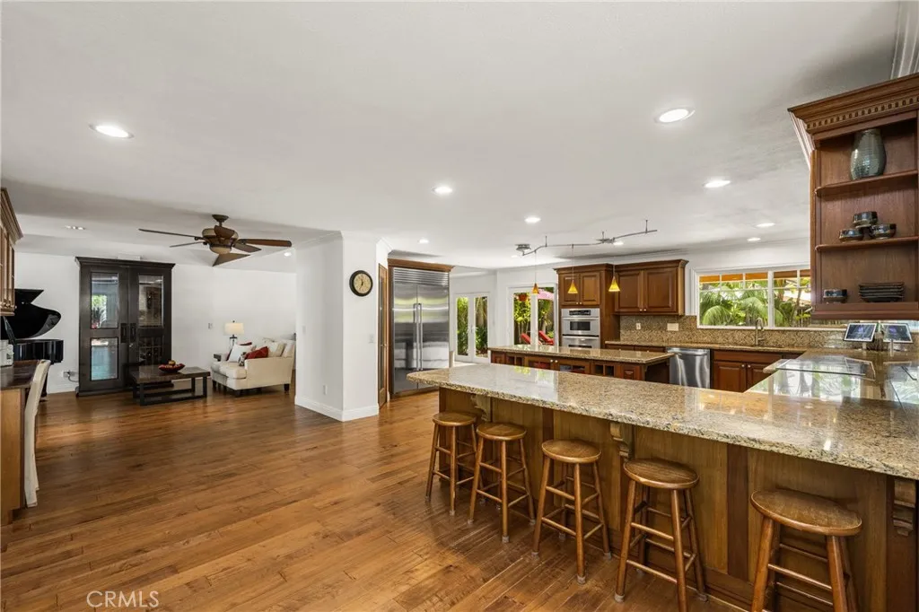 Extra large kitchen area with Lots of seats and extra cabinets, recessed lights.