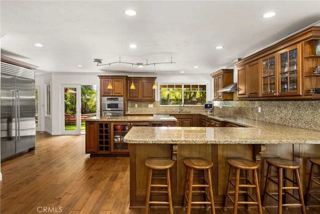 Extra large kitchen area with Lots of seats and extra cabinets, recessed lights.