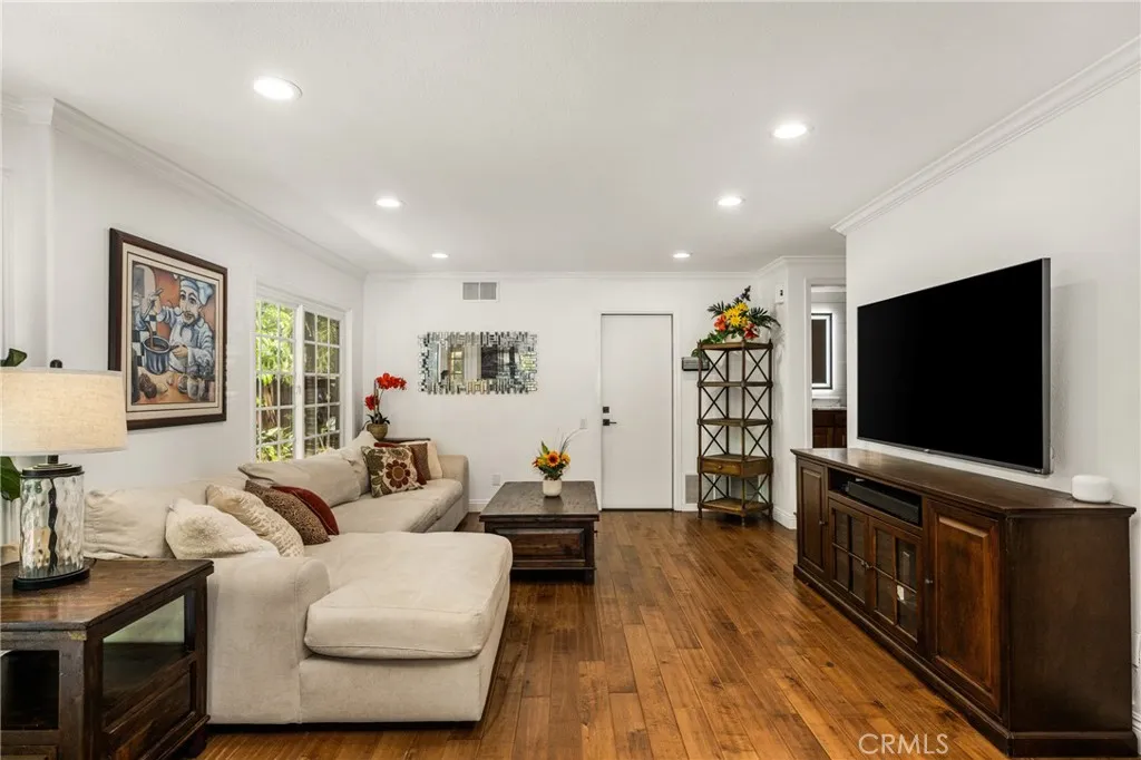 Next to the Kitchen -family room sitting area. recessed lights- door leading to the 2 car garage.