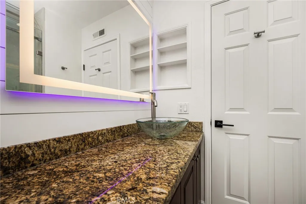 Bathroom with upgraded custom mirrors and faucet and sink.