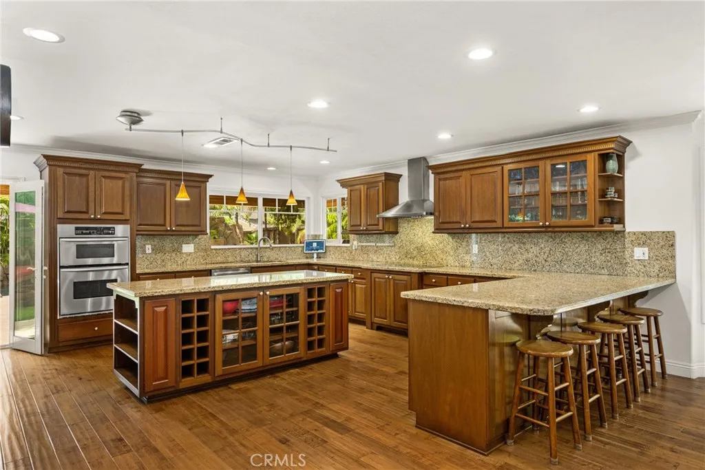 Extra large kitchen area with Lots of seats and extra cabinets, recessed lights.