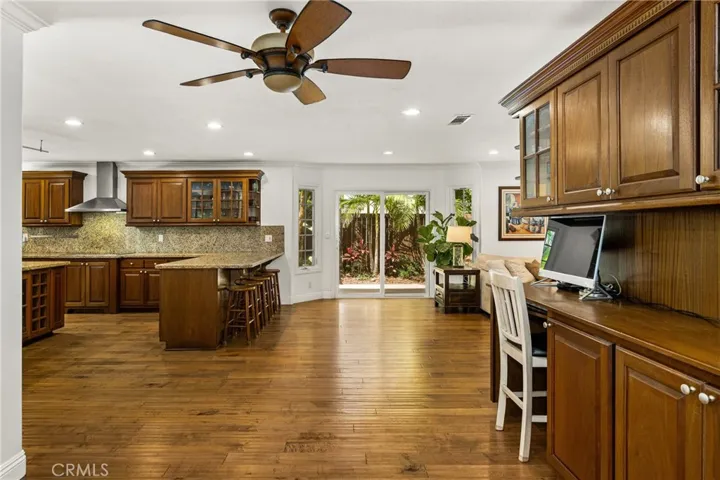 Extra large kitchen area with a ceiling fan and Lots of extra cabinets and a sitting area.