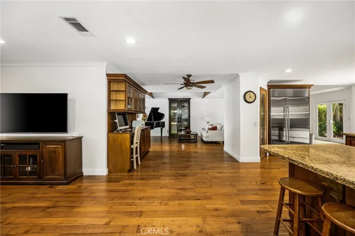 Next to the Kitchen -family room sitting area. recessed lights- door leading to the 2 car garage.