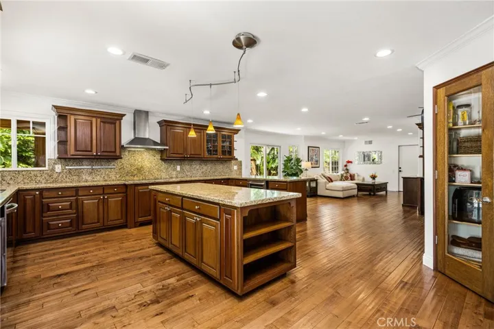 Extra large kitchen area with Lots of seats and extra cabinets, recessed lights.