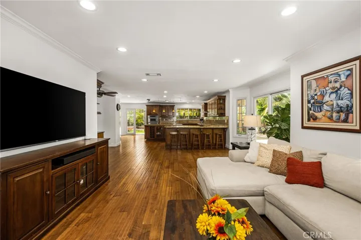 Next to the Kitchen -family room sitting area. recessed lights- door leading to the 2 car garage.