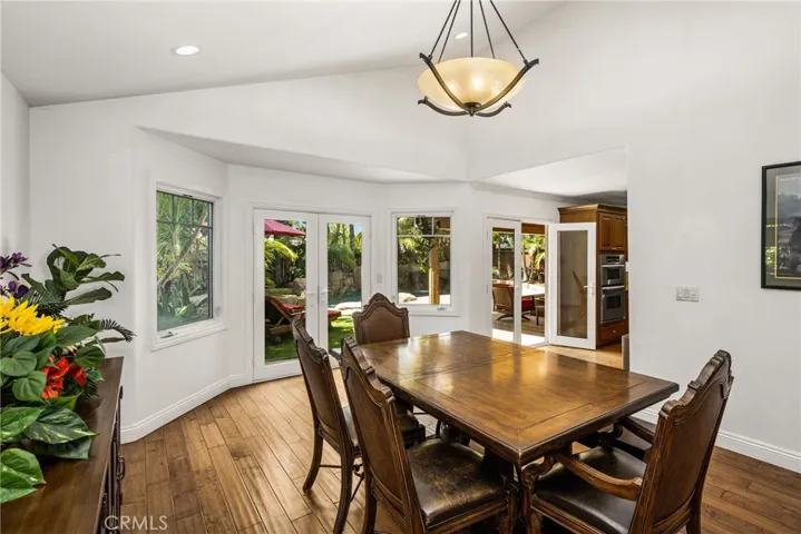 Separate dining room, with Chandelier looking out to the magnificent Pool and custom greenery....