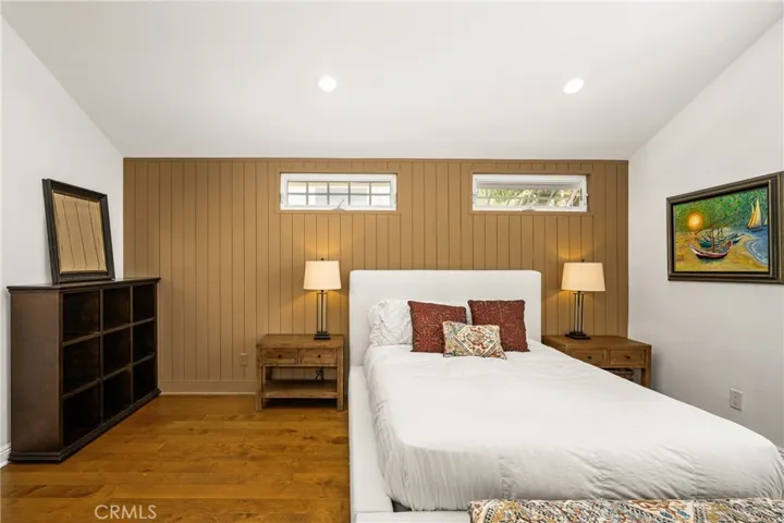 One of the bedrooms upstairs..High ceiling and recessed lights and windows.