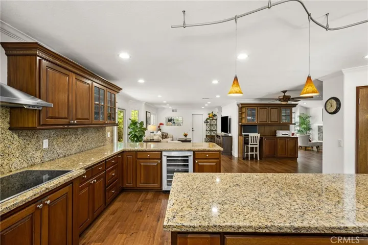 Extra large kitchen area with Lots of seats, extra cabinets, recessed lights. & wine cooler.