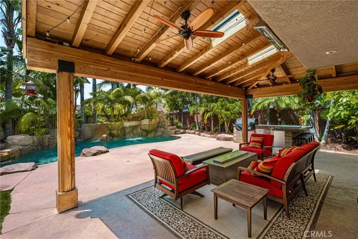 Sitting outside with the cover hang with a ceiling fan looking the beautiful Private swimming pool and the lush landscape....