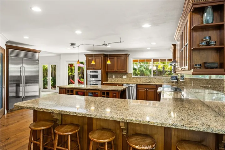 Extra large kitchen area with Lots of seats and extra cabinets, recessed lights.