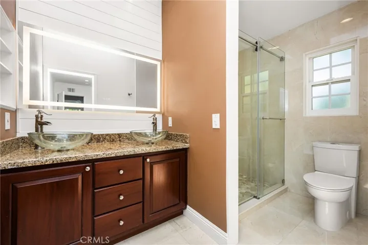 Secondary bathroom upstairs with walk-in shower and 2 customs sinks.