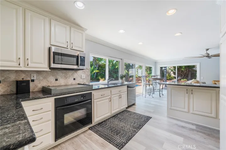 Updated kitchen overlooking backyard entertaining spaces