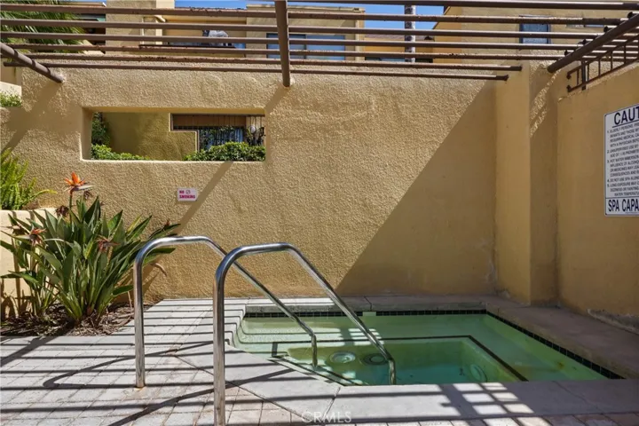 Jacuzzi in pool area to the right of complex