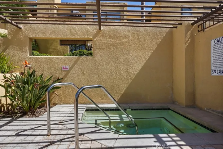Jacuzzi in pool area to the right of complex