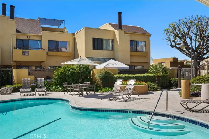 Pool on the left side of condo with waterfall