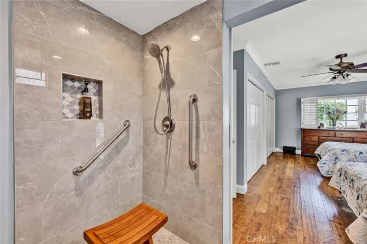 Large Ptrimary ha walk in shower and accessible features, wall to wall custom closets in bedroom