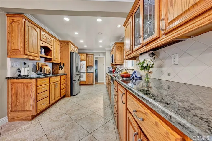 Travertine tiled floors,  dual paned windows, wood cabinets with roll out drawers tons of storage!