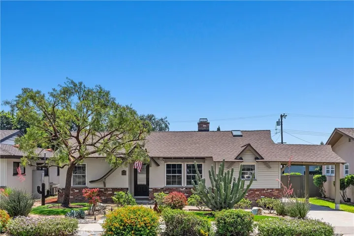 The award-winning front yard, recognized with the "City Beautification Award", sets the tone with drought-resistant landscaping, boulders, artwork, hardwired lighting, and a welcoming front porch shaded by a Sunsetter retractable awning (which also is equipped with lighting).