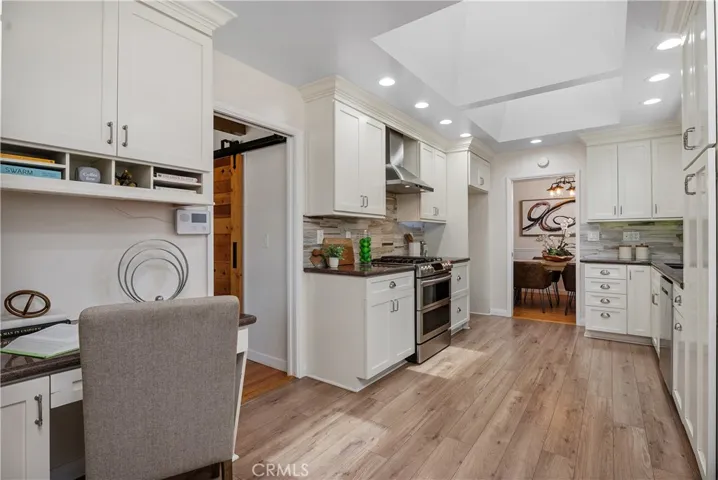 The kitchen was remodeled from top to bottom with granite countertops, marble tile backsplash, soft-close cabinetry, custom moldings, recessed lighting, and stainless appliances.