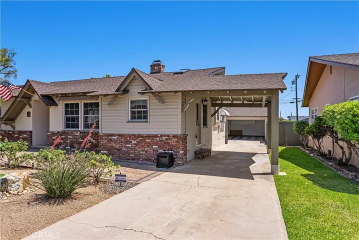 The porte cochere adds classic architectural character to the home and has been rebuilt and reinforced with cement pillars, blending charm, function, and lasting structural support.