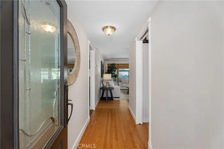 A leaded glass entry door with hand-crafted decorative glass welcomes you inside, paired with a Ring doorbell for modern convenience.