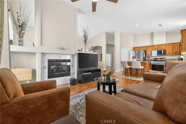 Family room shares a dual fireplace with forma Living room