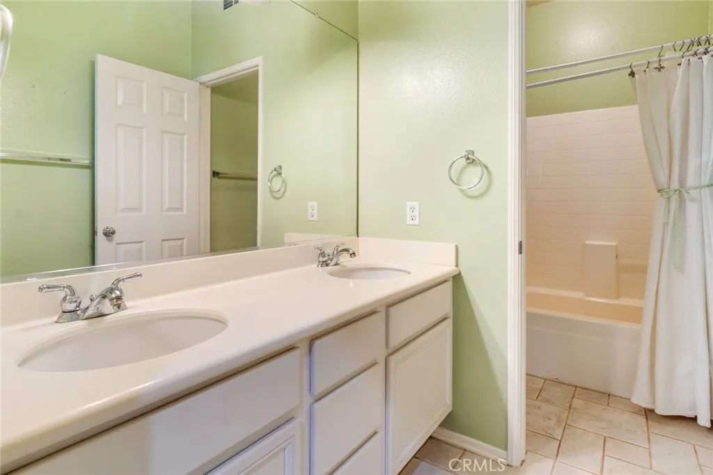 Hall Bathroom with Dual Sinks and Privacy Toilet and Shower