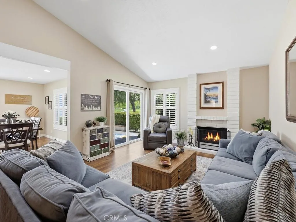 Family room with pitched ceiling, recessed lighting and fireplace
