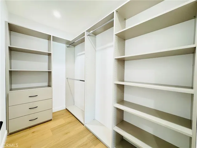 Large walk in closet with closet system