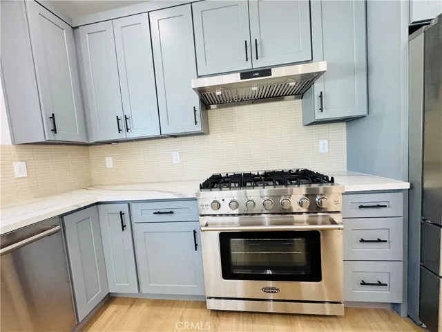 Stove/oven, hood, and tons of cabinets