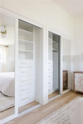 Primary bedroom includes custom closets.