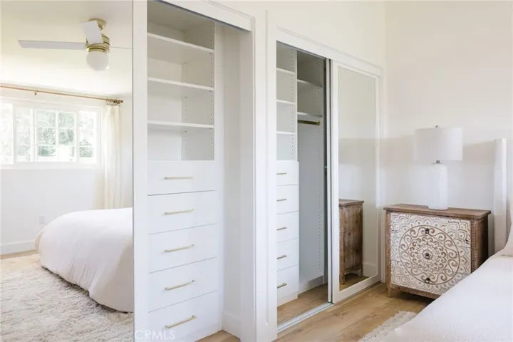 Primary bedroom includes custom closets.