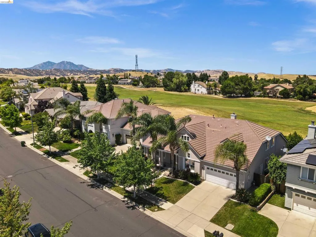 Aerial perspective showcasing residential properties bordering a green expanse