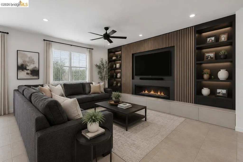 Living area featuring a built-in media wall with wood-slat paneling, integrated shelving with accent lighting, and a modern linear fireplace