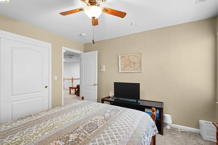 Carpeted room featuring a ceiling fan with integrated lighting, recessed lighting, and neutral wall tones
