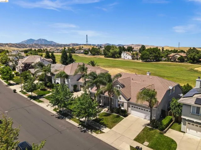 Aerial perspective showcasing residential properties bordering a green expanse