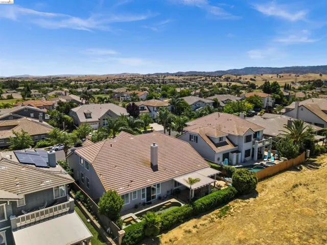 Aerial perspective showcasing a residential neighborhood with distant hills