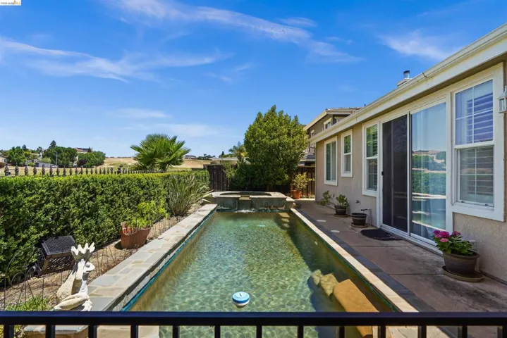 Private backyard featuring an elongated swimming pool with an integrated spa