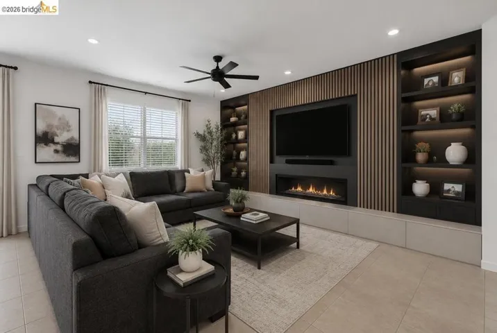 Living area featuring a built-in media wall with wood-slat paneling, integrated shelving with accent lighting, and a modern linear fireplace