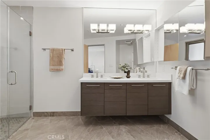 Primary ensuite bathroom with dual vanities