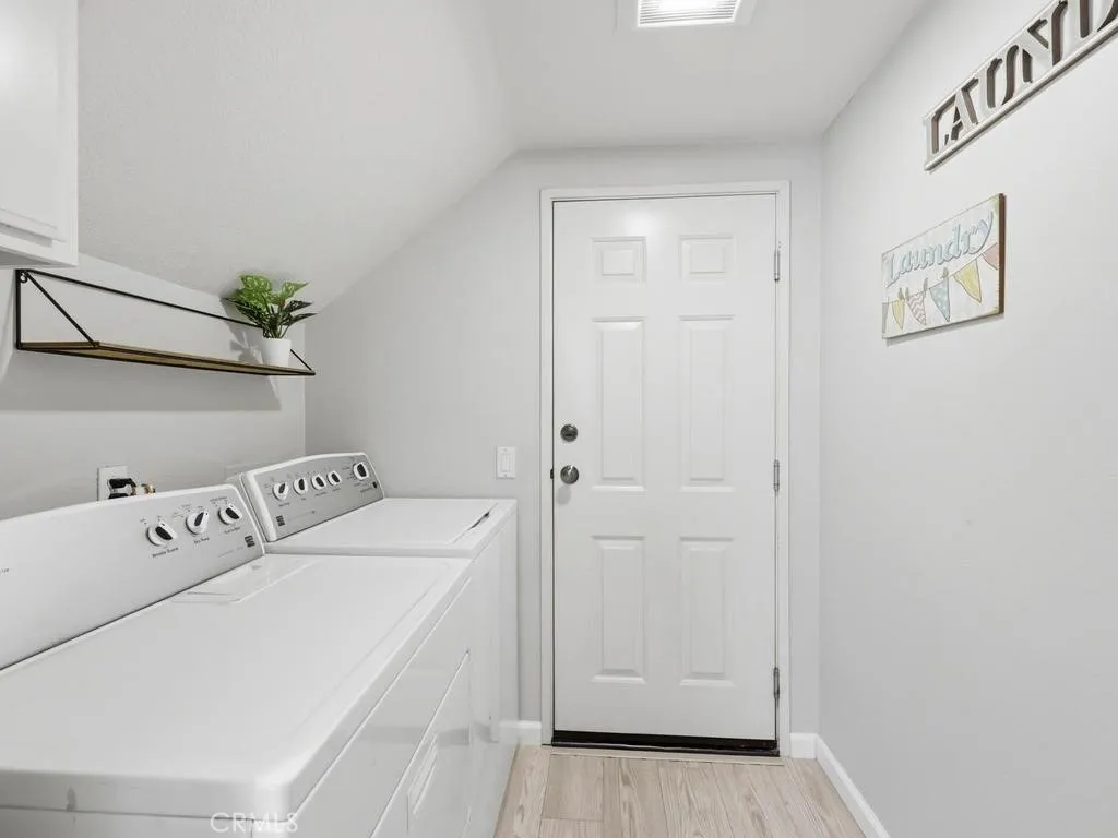Laundry room downstairs with door to attached one car garage