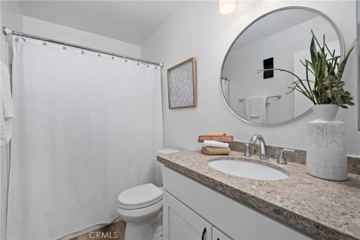 Hall bathroom with stone top vanity