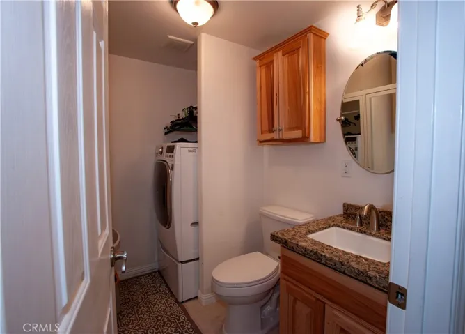 downstairs half bath with washer/dryer combo