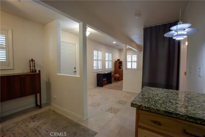 from kitchen showing dining area and entry from front door