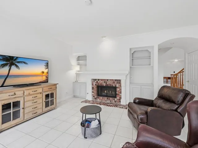 Family room has double sided fireplace with built in shelving